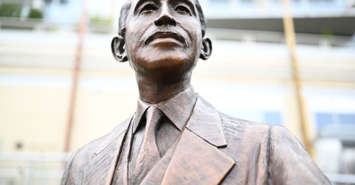 Close-up of a bronze statue depicting a distinguished gentleman in Charlotte, NC.